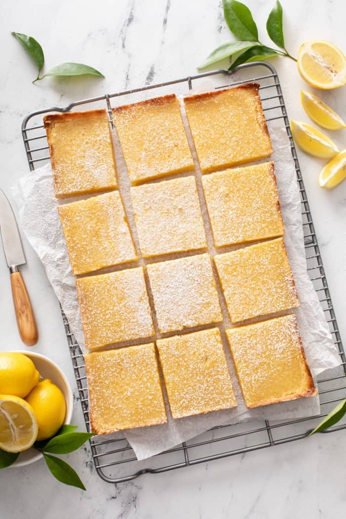 Overhead view of sliced lemon bars on a wire cooling rack.