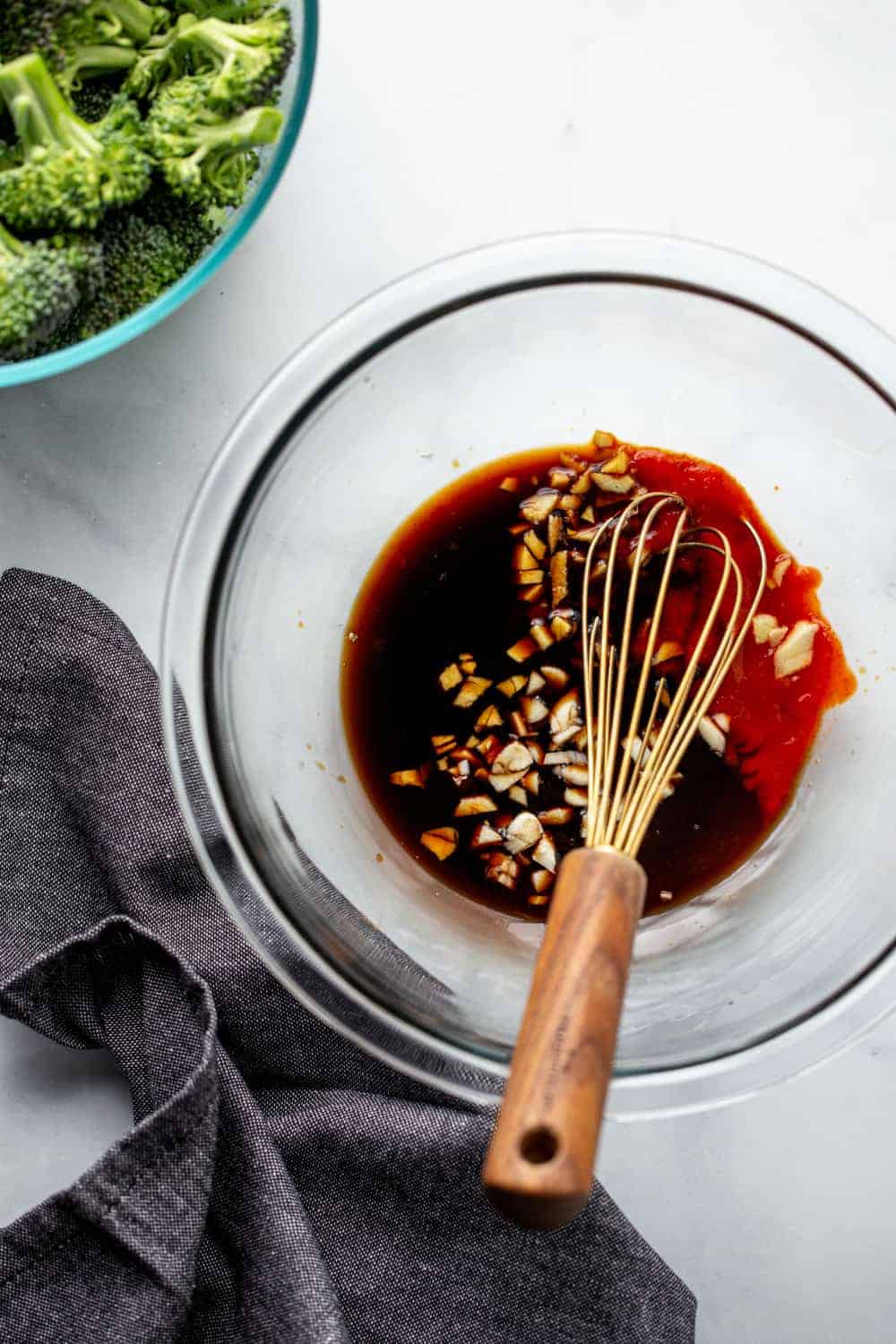Ingredients for honey soy chicken in a bowl with a whisk