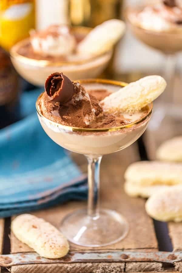 Tiramisu martini in a coupe glass surrounded by ladyfinger cookies