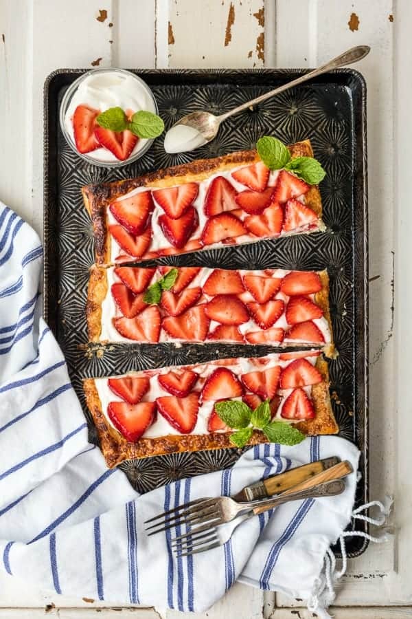 Overhead view of puff pastry strawberry tart on a baking sheet