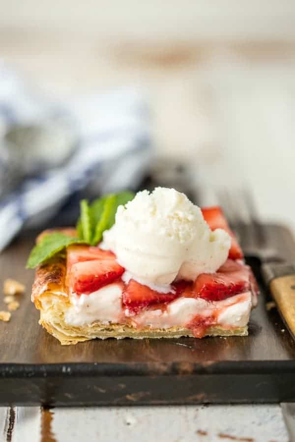 Puff pastry strawberry tart topped with vanilla ice cream and garnished with mint