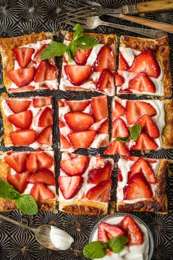 Sliced strawberries over mascarpone filling in a puff pastry tart shell