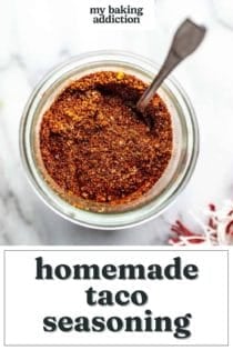 Overhead view of a jar of homemade taco seasoning with a spoon in it. Text overlay includes recipe name.