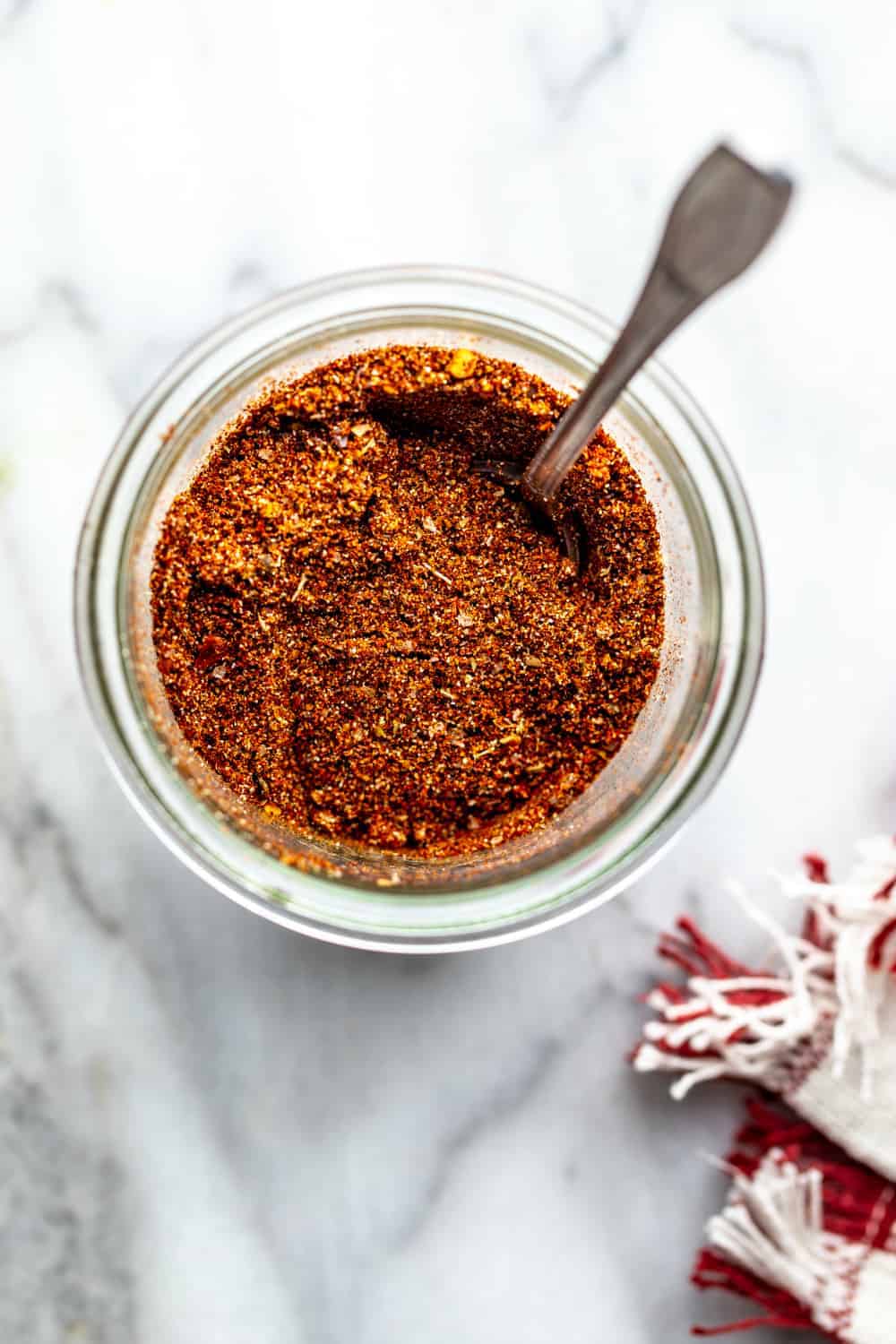 overhead view of spoon in a jar of homemade taco seasoning