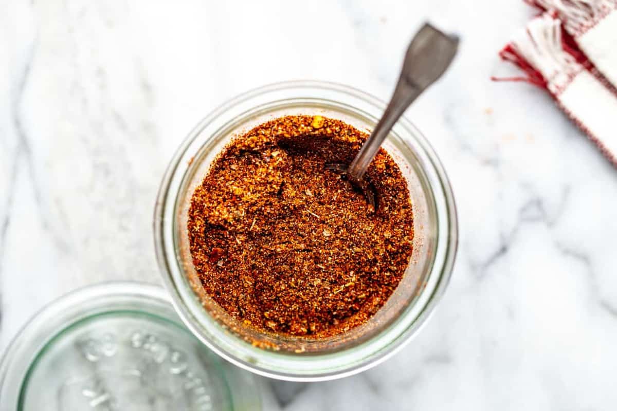 overhead view of spoon in a jar of homemade chili seasoning