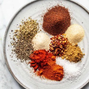 Spices for homemade taco seasoning arranged on a plate