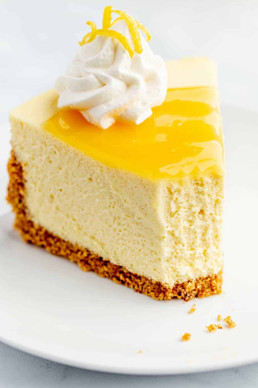 Slice of lemon cheesecake with a bite taken