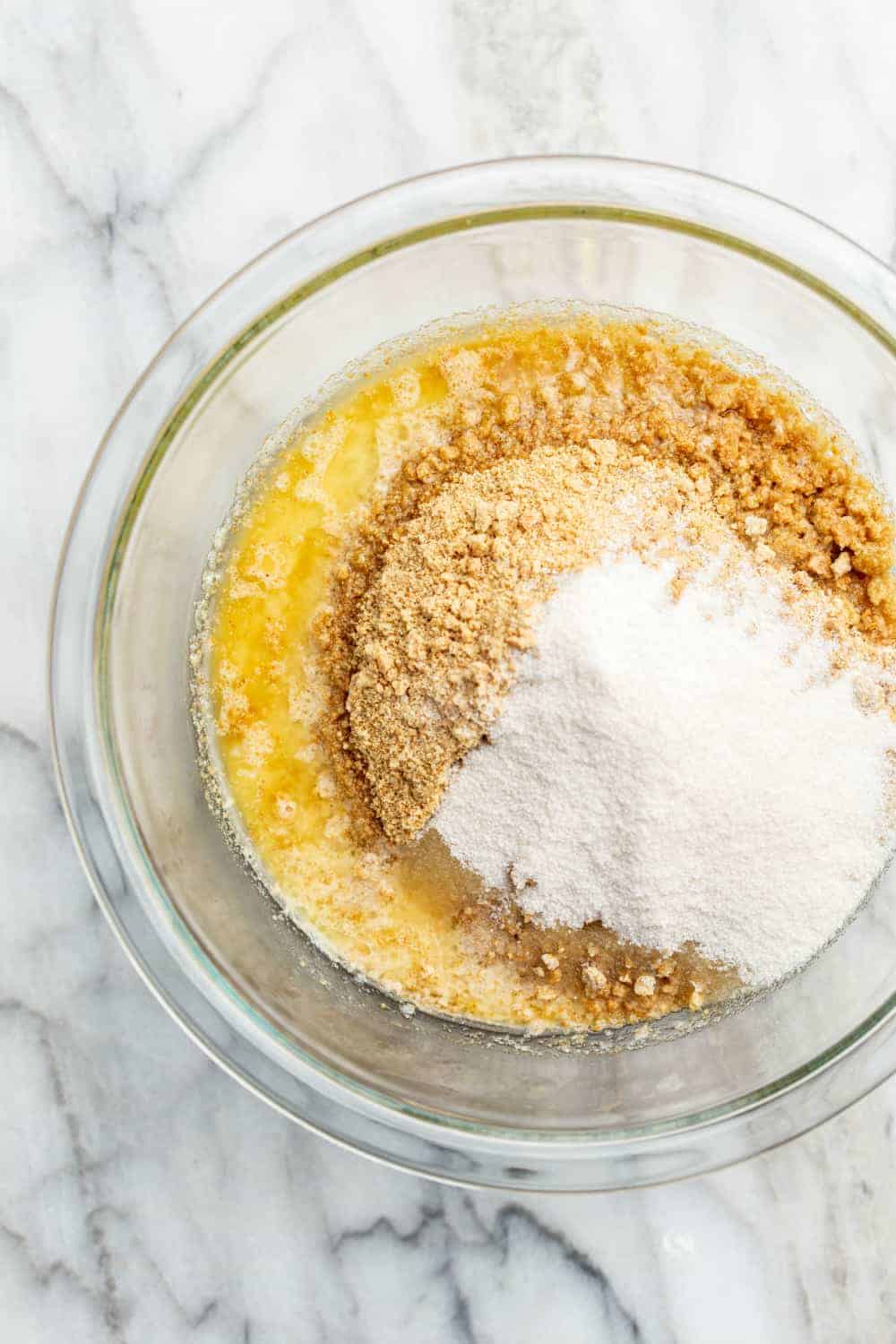 Graham cracker crumbs, sugar and melted butter in a bowl to make graham cracker crust