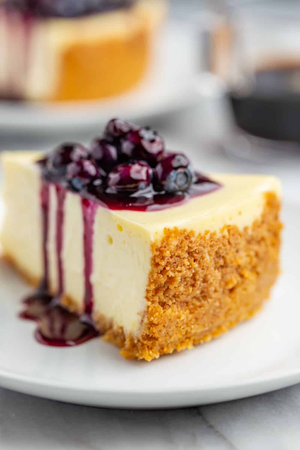 Slice of cheesecake with close up of the graham cracker crust