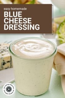 Glass jar filled with blue cheese dressing, with a chunk of blue cheese in the background. Text overlay includes recipe name.