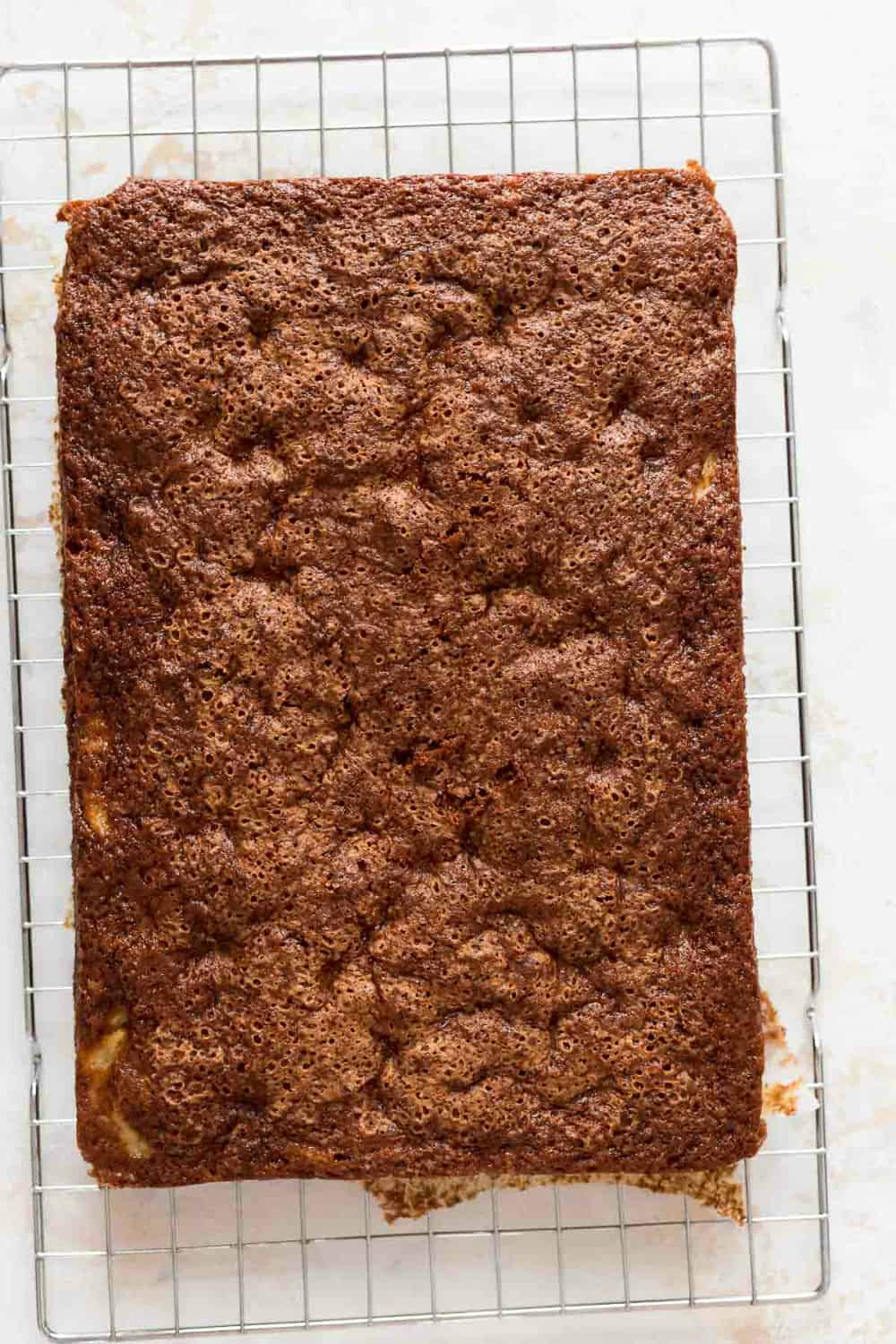 Freshly baked pineapple cake cooling on a wire rack