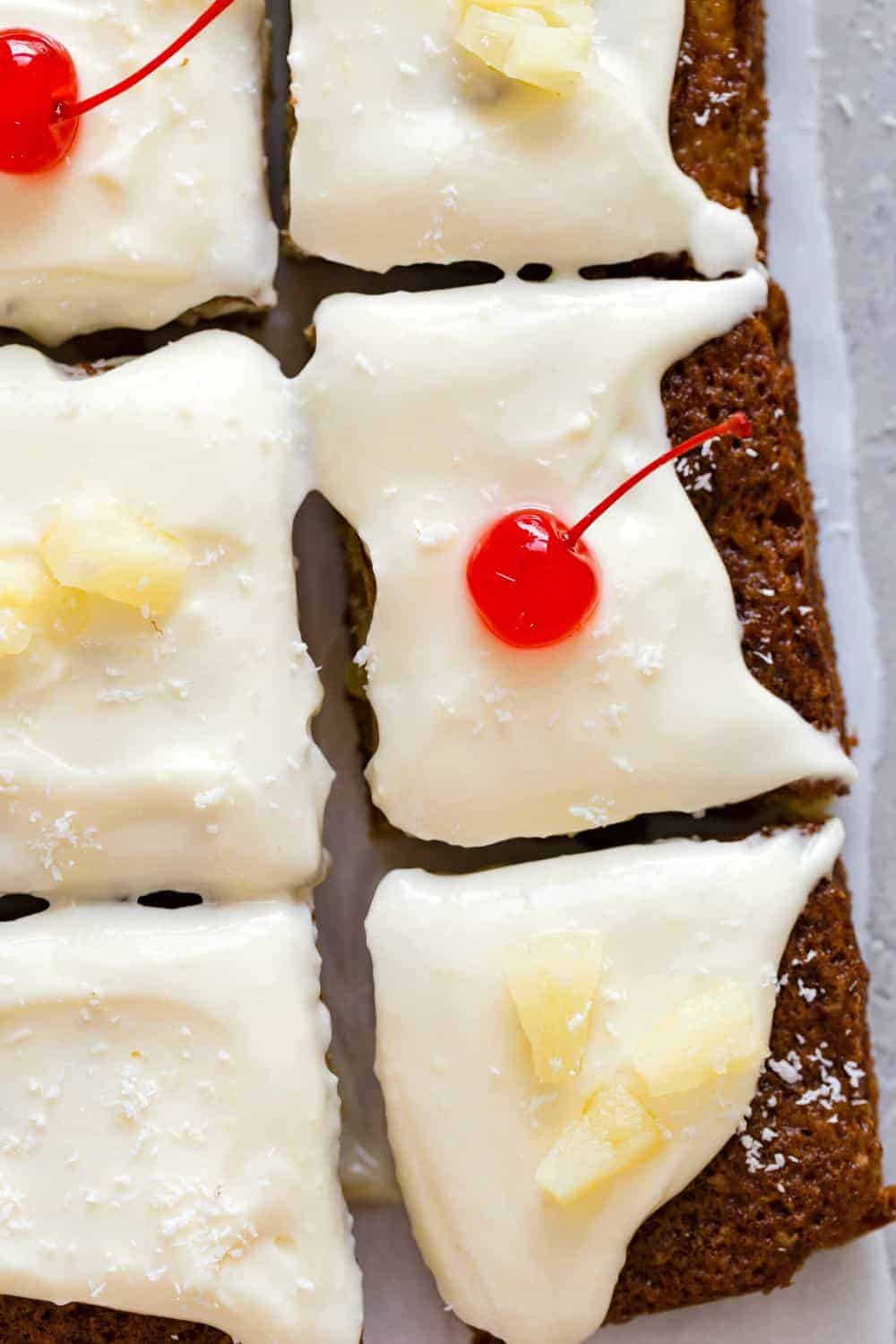 Sliced pineapple cake topped with cherries and pineapple