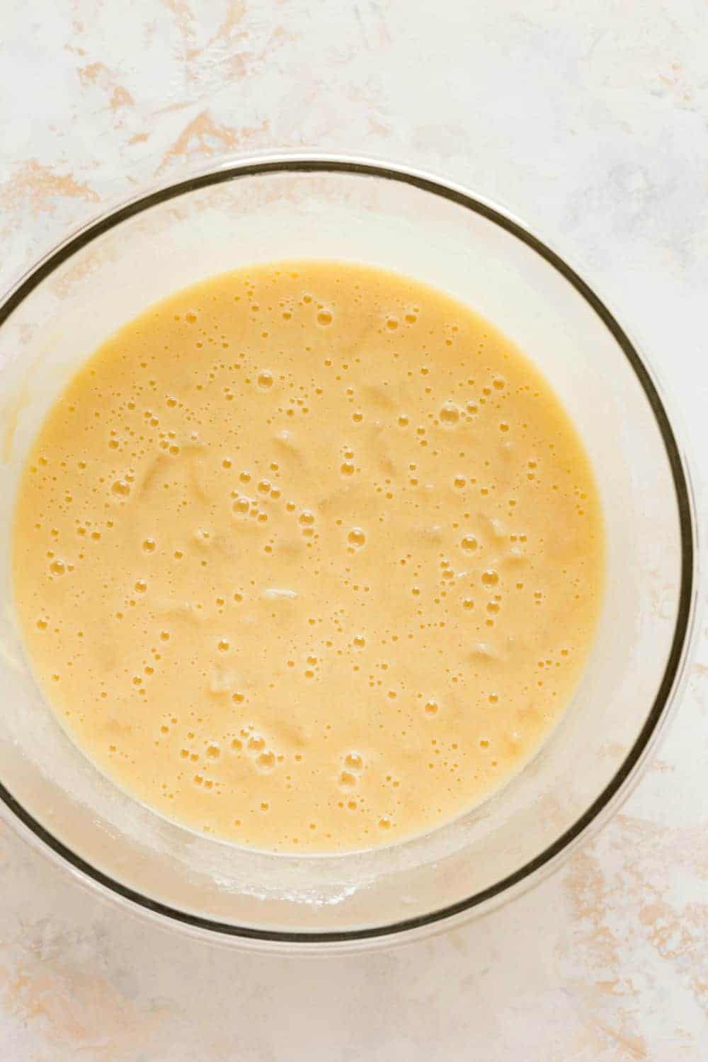 Pineapple cake batter in a glass bowl