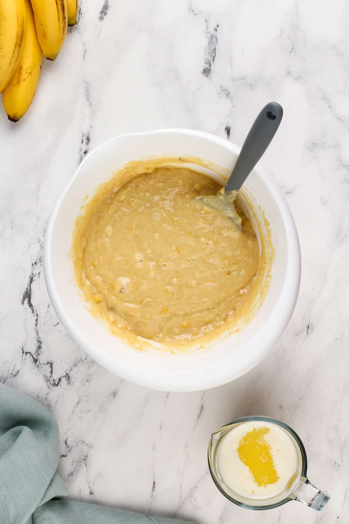 Batter for dominique ansel's banana bread in a white mixing bowl.