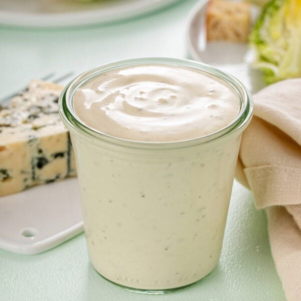 Glass jar filled with blue cheese dressing.