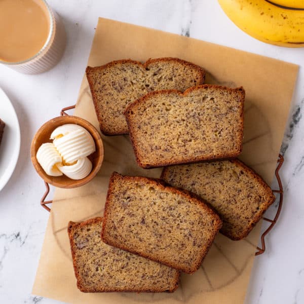 slices of dominique ansel's banana bread on a piece of parchment paper.