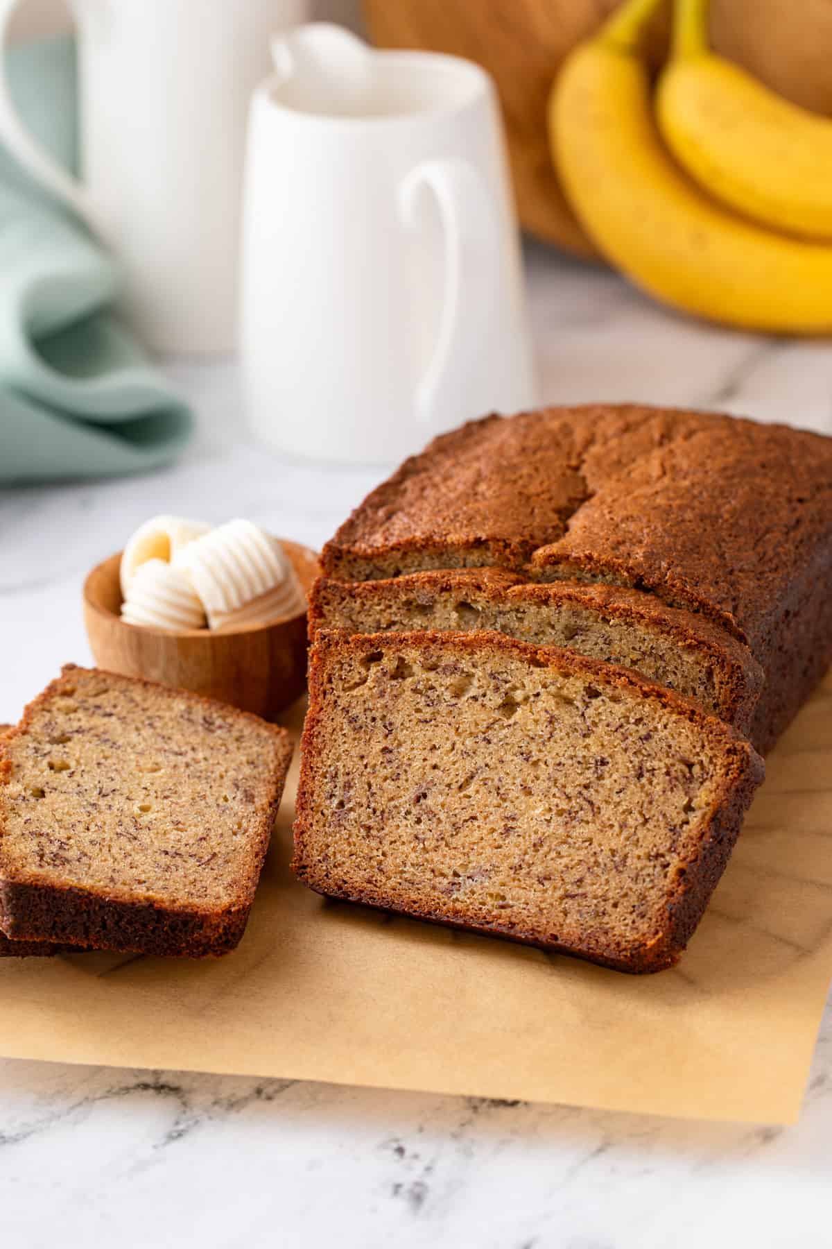 Loaf of dominique ansel's banana bread cut into slices.