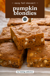 Sliced pumpkin blondie arranged on top of the rest of the sliced blondies on a piece of parchment paper. Text overlay includes recipe name.