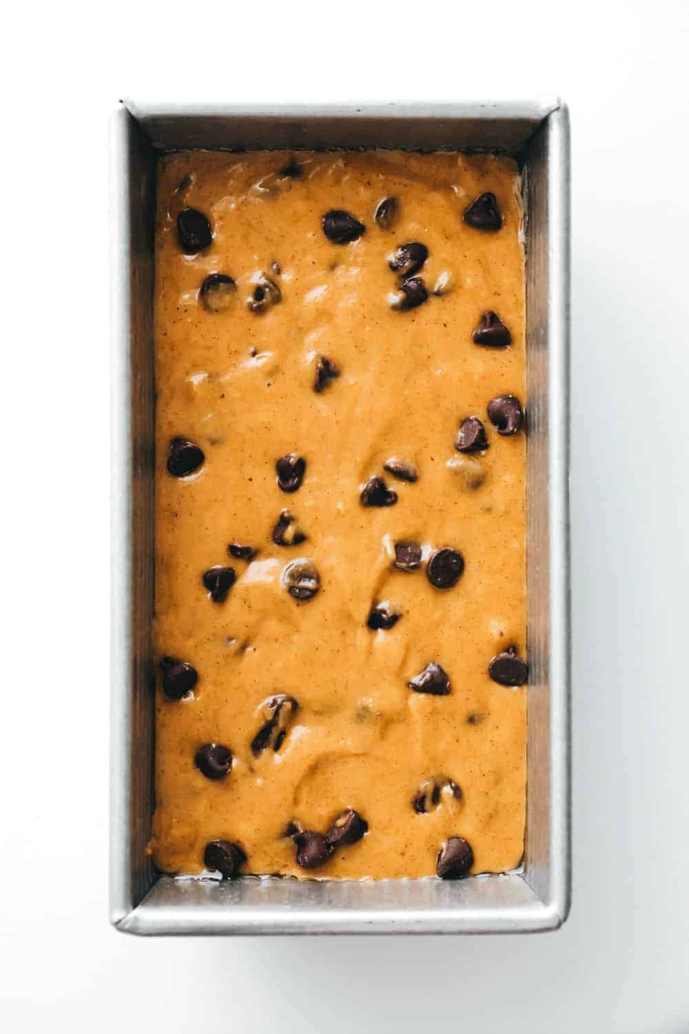 Batter for pumpkin chocolate chip bread in a loaf pan, ready to be baked
