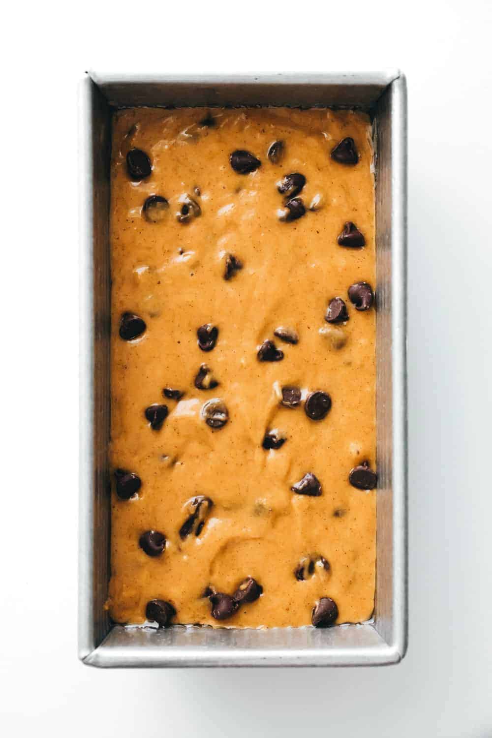 Batter for pumpkin chocolate chip bread in a loaf pan, ready to be baked