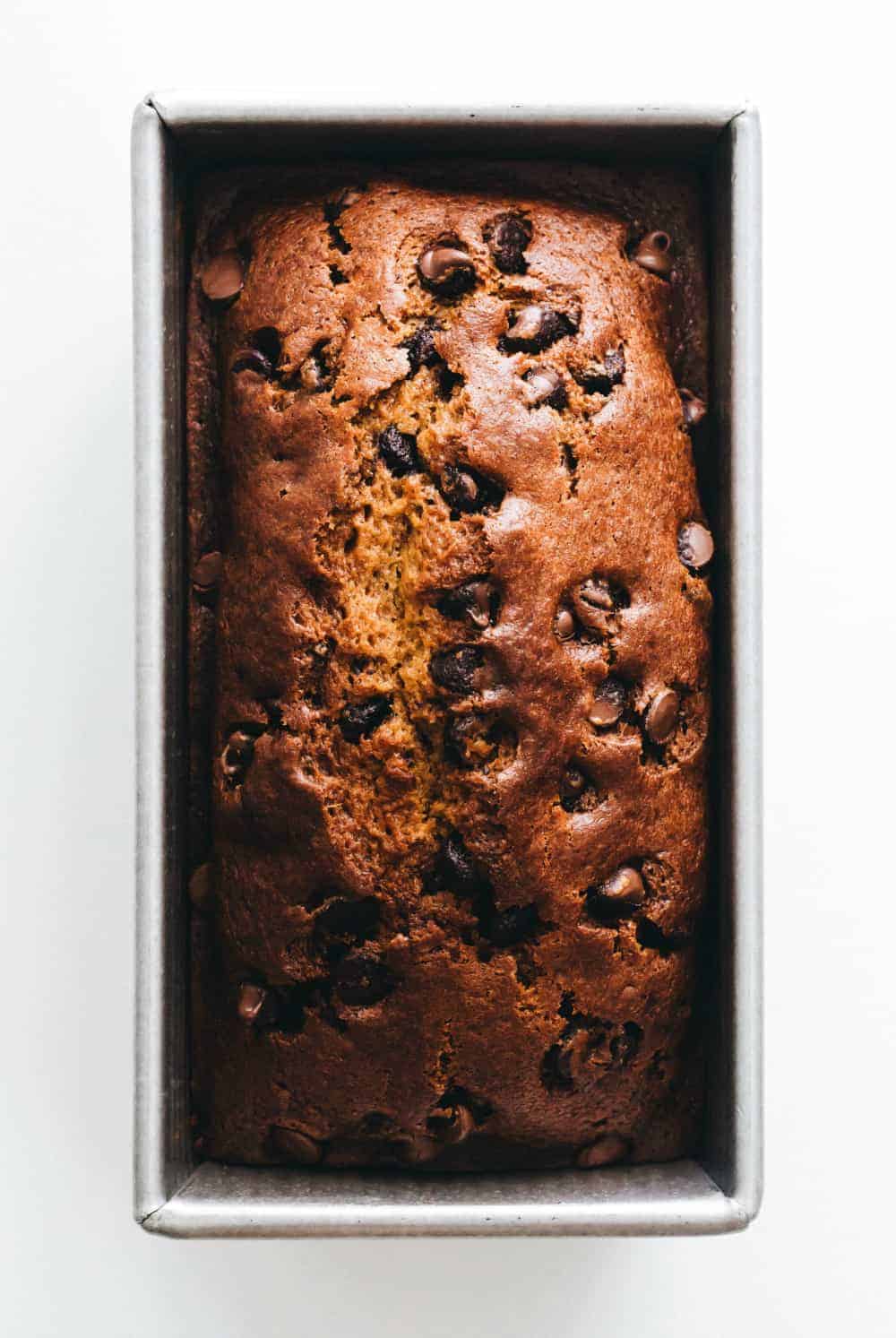 Overhead view of a freshly baked loaf of pumpkin chocolate chip bread