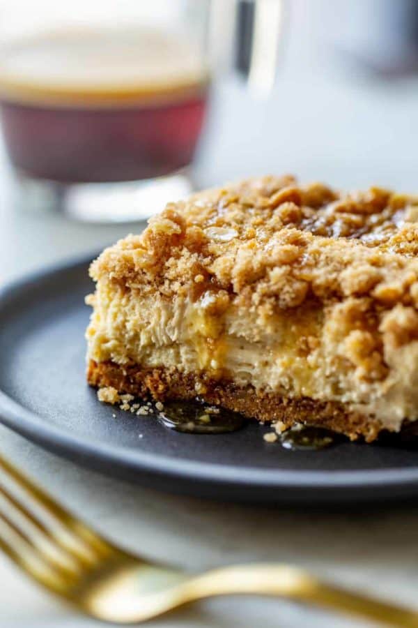 Close-up side view of a sliced maple streusel cheesecake bar