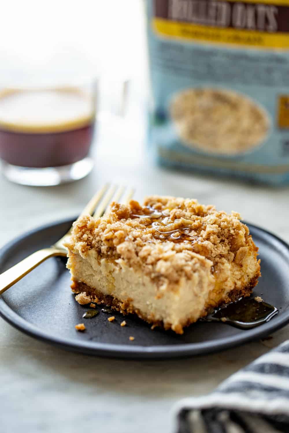 Plated maple streusel cheesecake bar with a cup of coffee