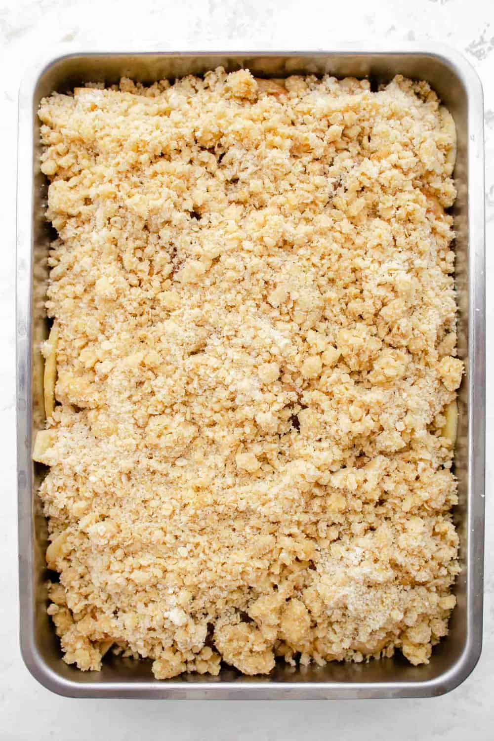 Apple crisp in a pan, ready to be baked