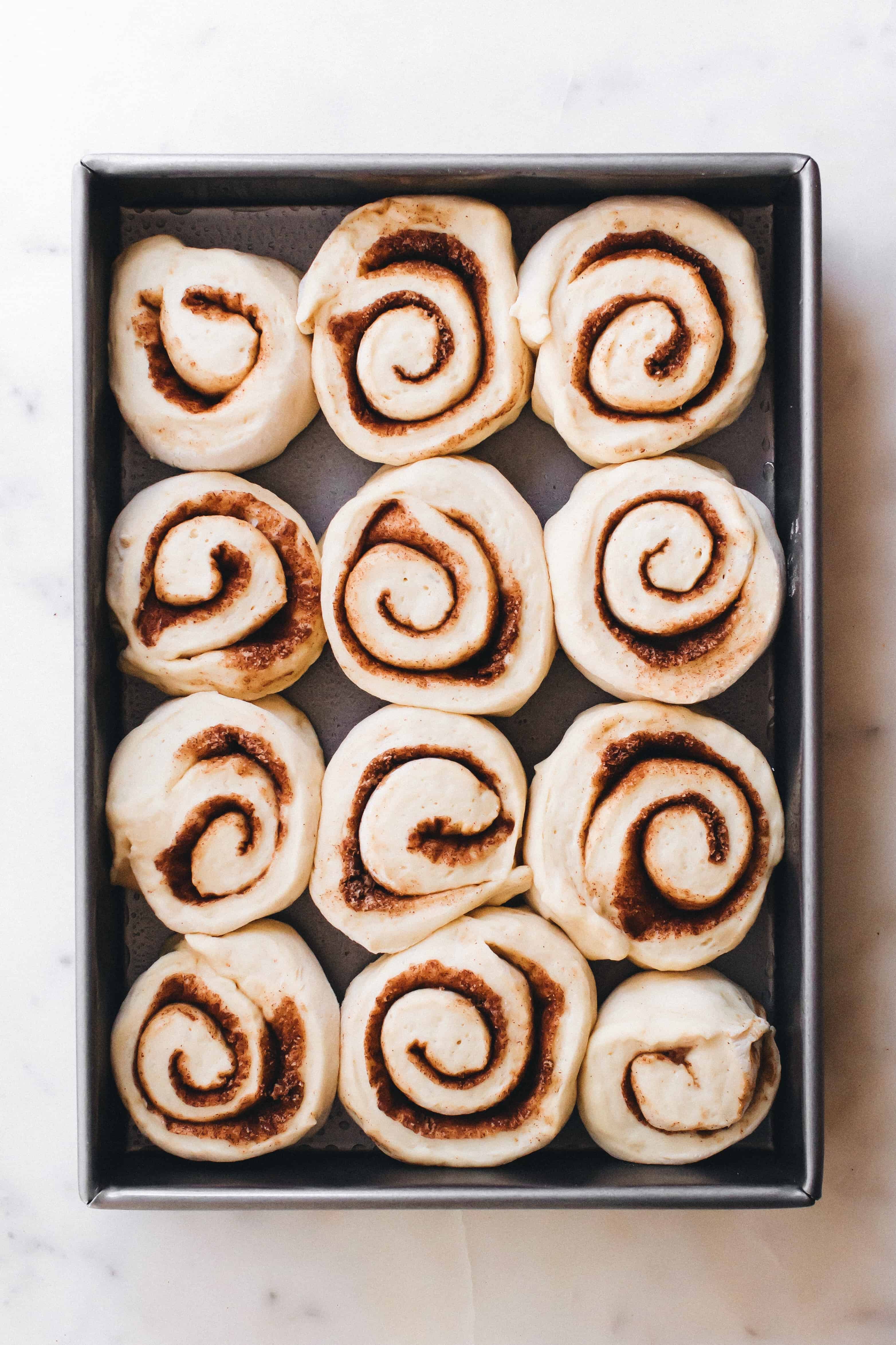 Rolled and cut chai cinnamon rolls in a baking pan, ready to be baked
