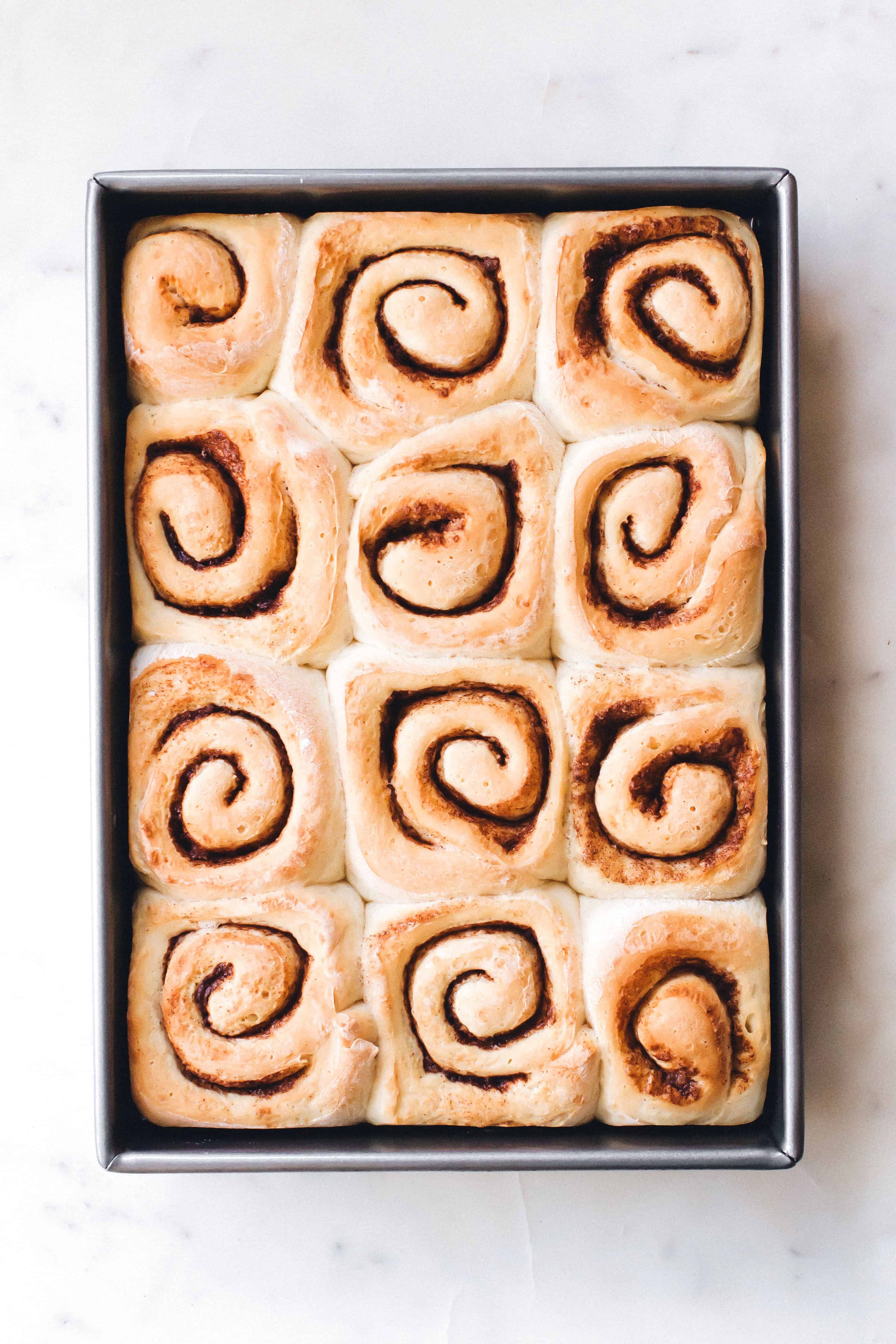 Freshly baked chai cinnamon rolls in a pan