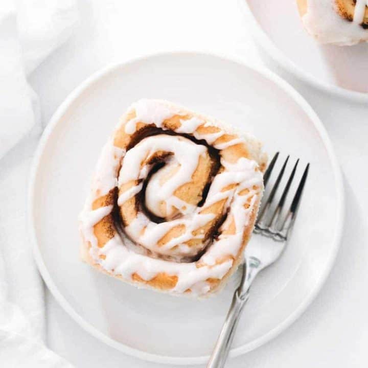 Plated maple chai cinnamon roll on a white plate