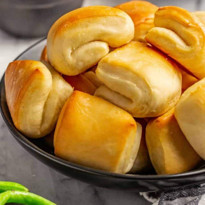 Close up of baked parker house rolls, showing the folded shape