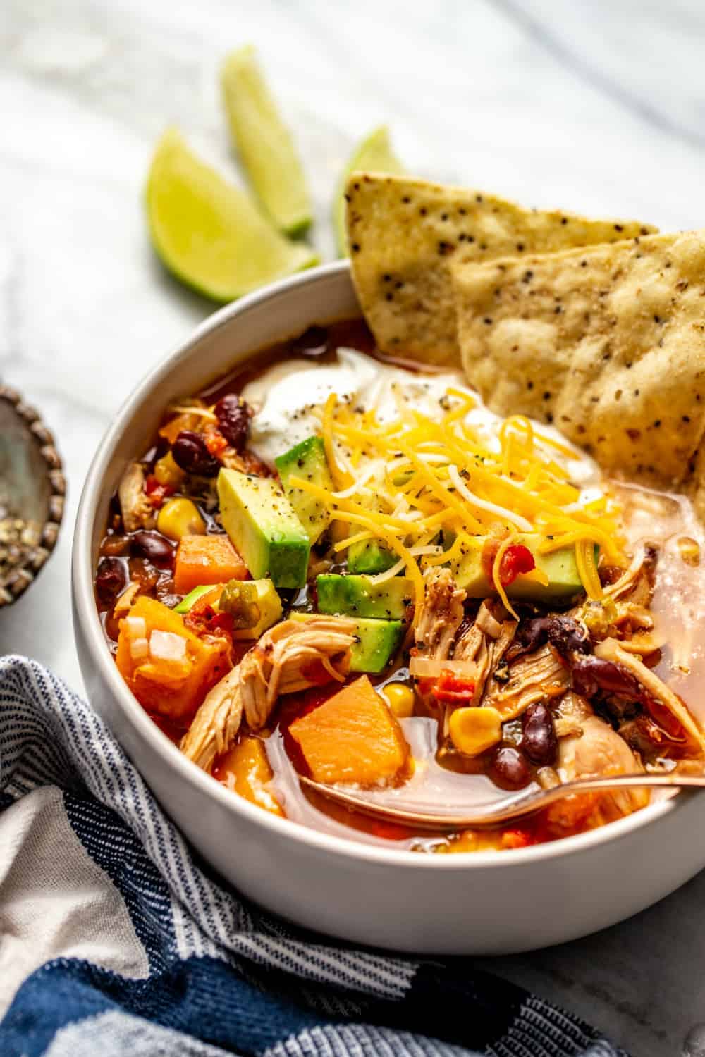 Close up of a bowl of chicken tortilla soup garnished with tortilla chips