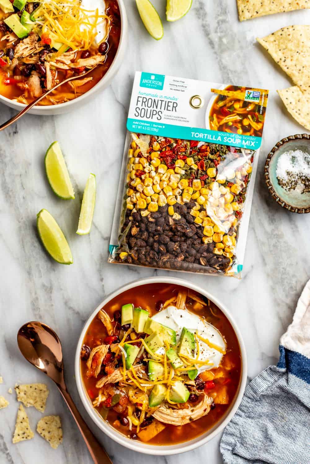 Bowl of chicken tortilla soup alongside a tortilla soup mix