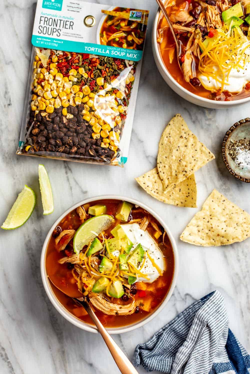 Easy tortilla soup mix alongside finished bowls of tortilla soup using rotisserie chicken