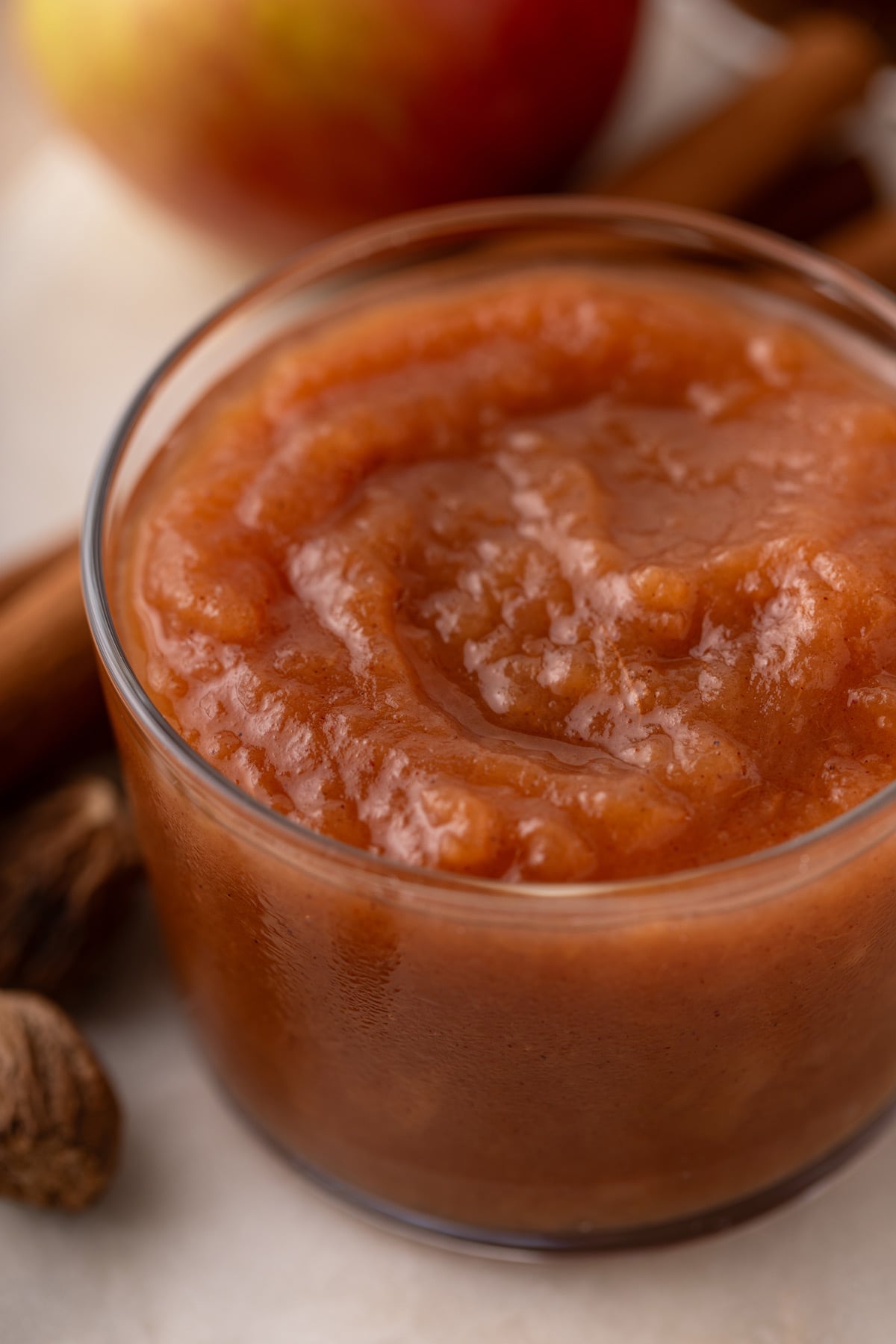Close up of crockpot applesauce in a small glass bowl.