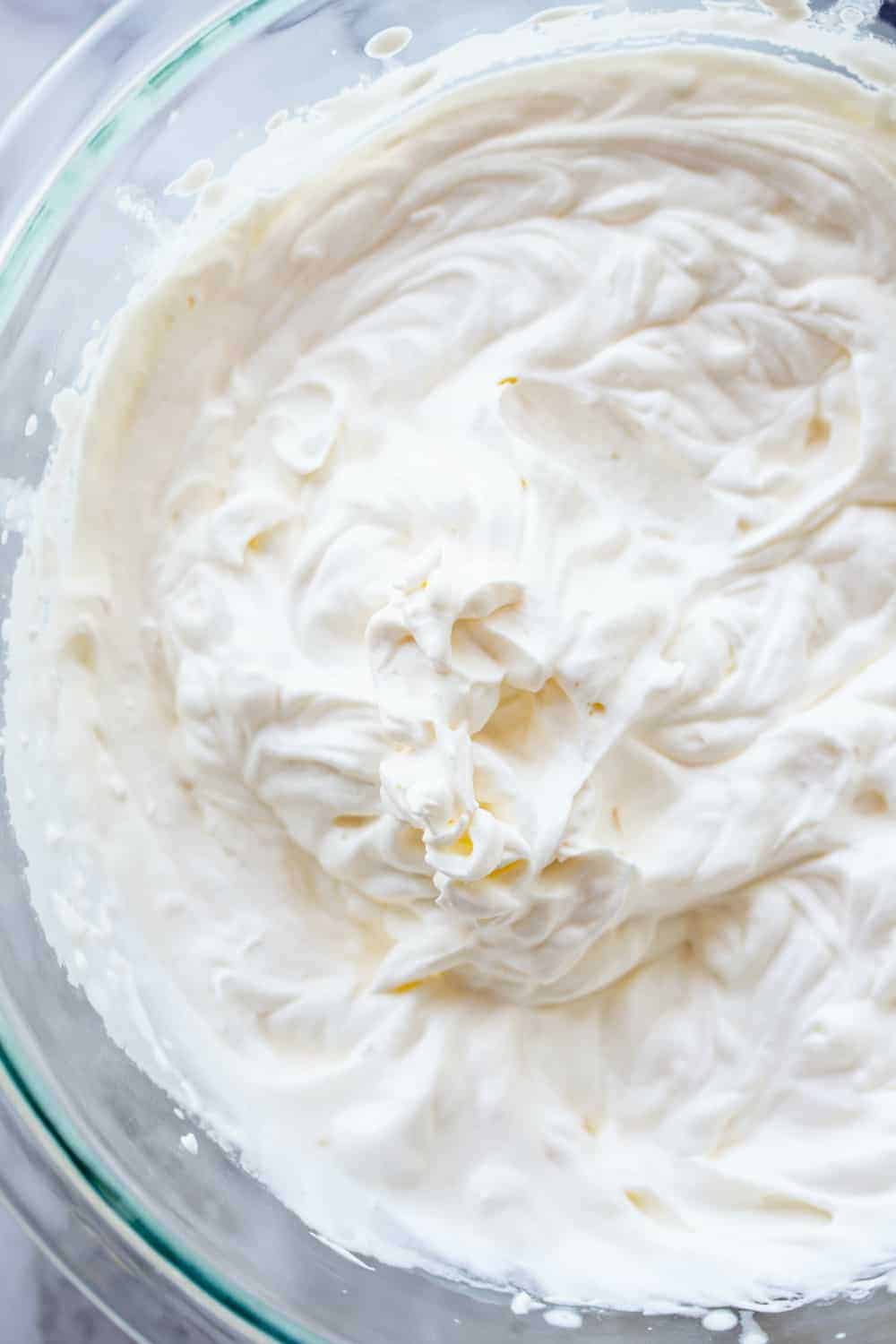 Close up of a glass mixing bowl of homemade whipped cream