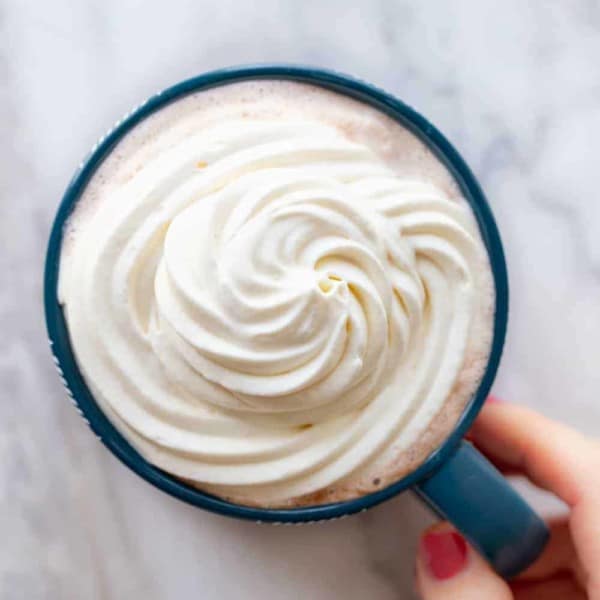 Mug of coffee topped with freshly whipped cream