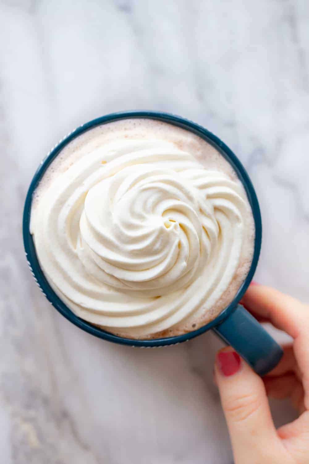 Mug of coffee topped with freshly whipped cream