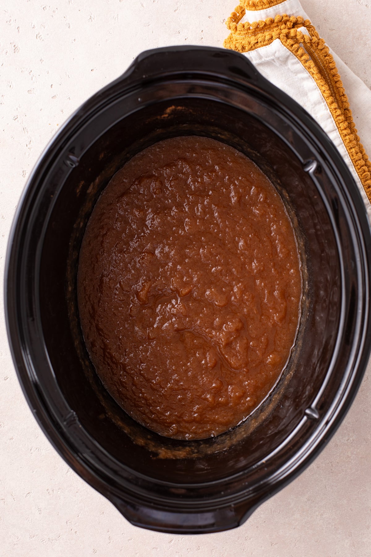 Pureed applesauce in the crock of a slow cooker.
