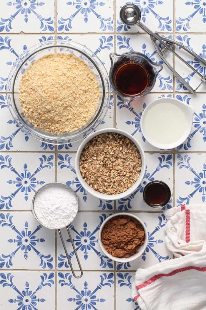 Rum ball ingredients arranged on a blue and white tiled countertop