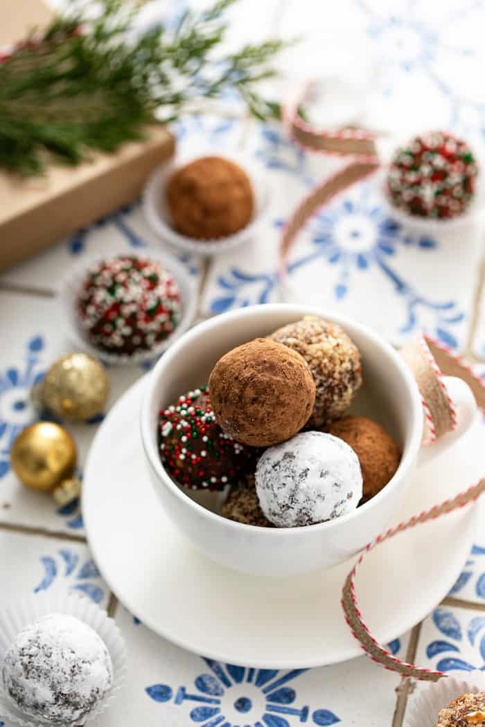 Rum balls with assorted toppings in a white bowl