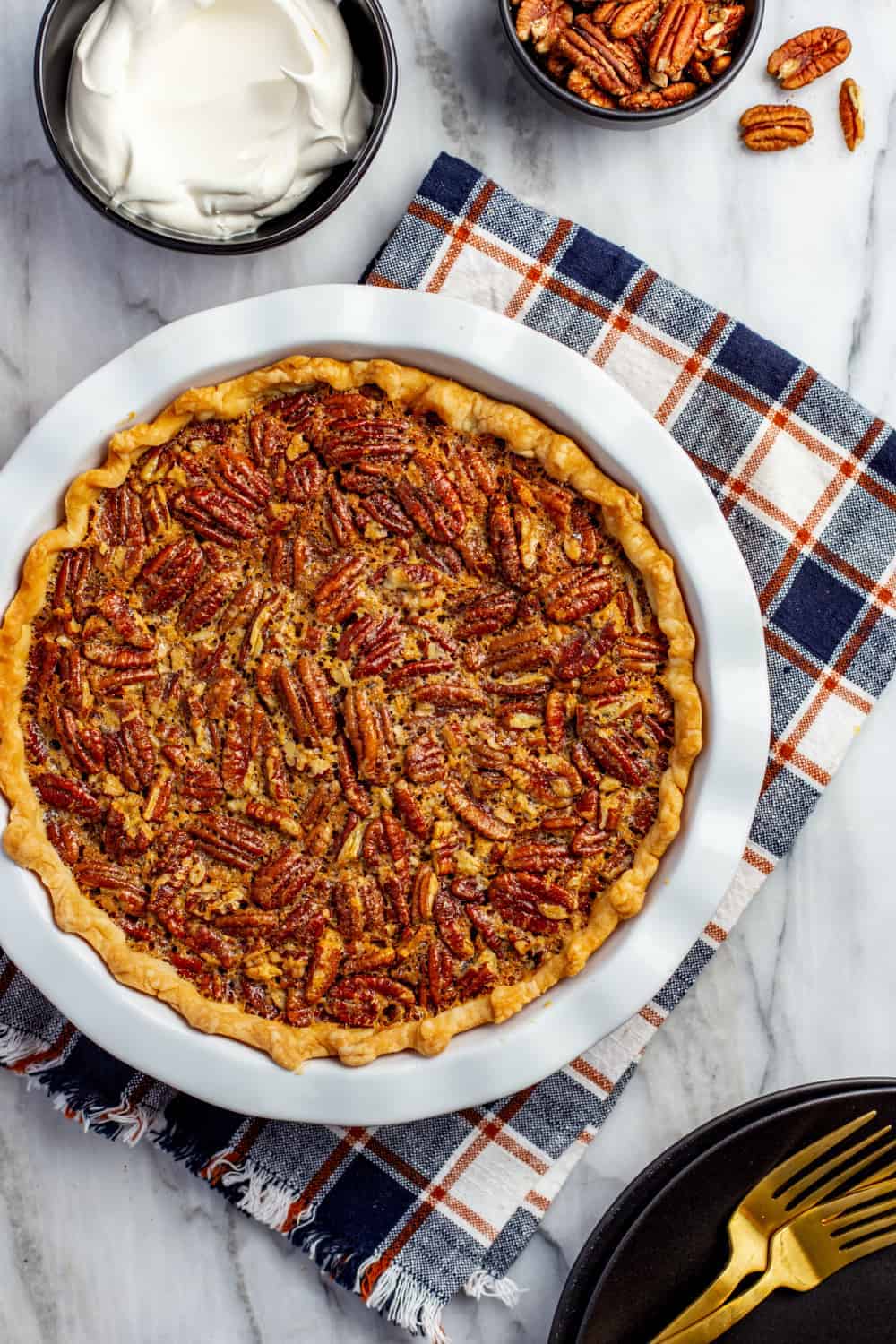 Baked classic pecan pie in a white pie dish