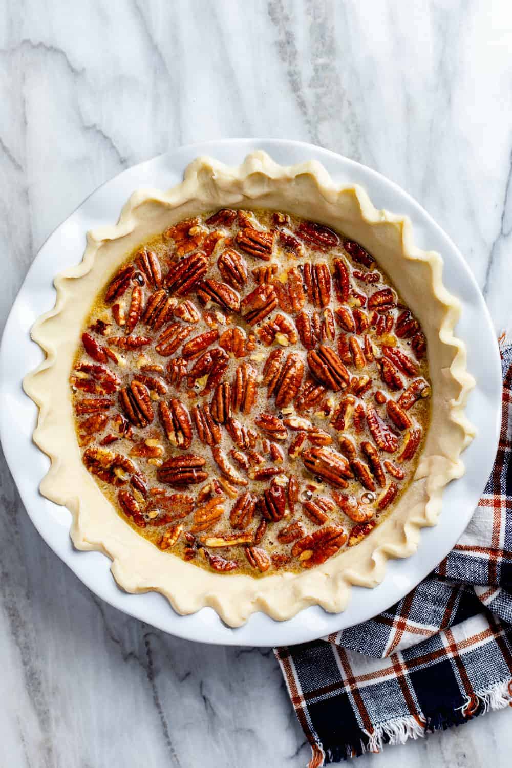 Overhead view of classic pecan pie ready to go in the oven