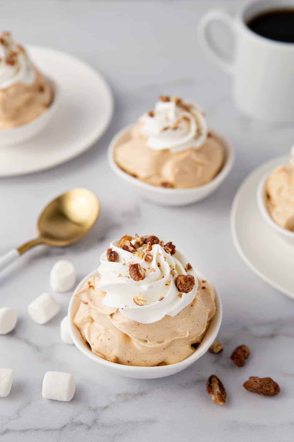 Bowls of pumpkin spice fluff on a marble surface