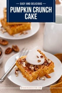 Slice of pumpkin crunch cake topped with a dollop of whipped cream on a white plate. Text overlay includes recipe name.