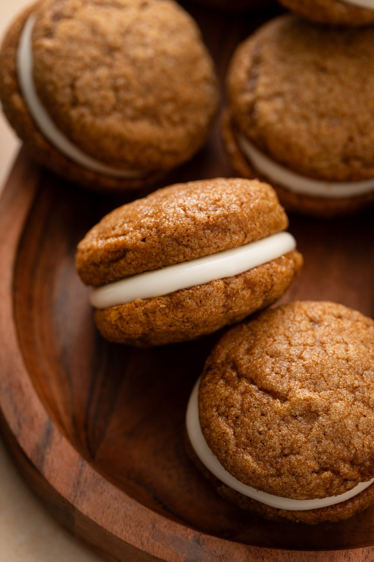 Close up of pumpkin molasses cookies on a wood platter.