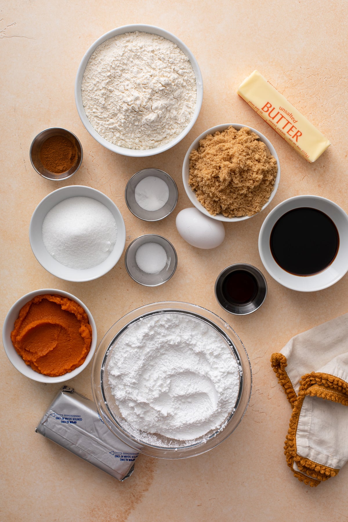 Ingredients for pumpkin molasses sandwich cookies arranged on a countertop.