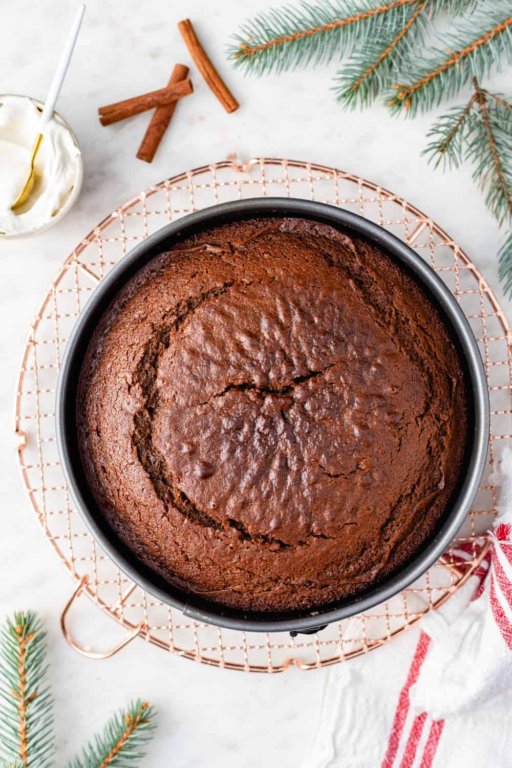 Overhead view of gingerbread cake cooling on a wire rack