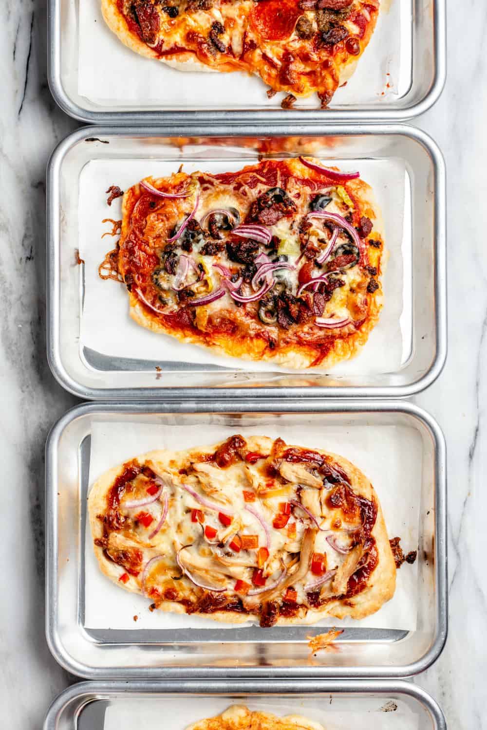 Assorted pizzas made with 30 minute pizza crust on mini baking sheets